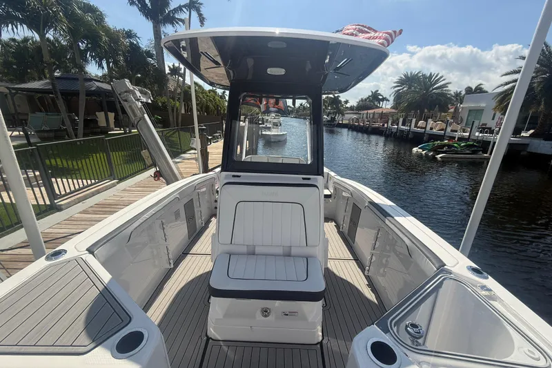 Slide: The Image of 2024 Yamaha Boats 255 FSH Sport H on a sunny canal, showcasing sleek interior design. - 7