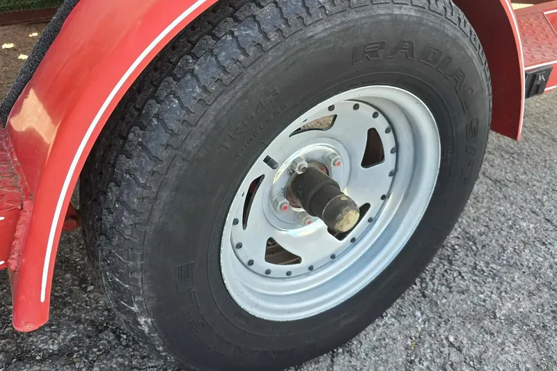 Slide: The Image of Red trailer wheel of 1998 Larson 190 Ski & Fish O/B boat. - 13