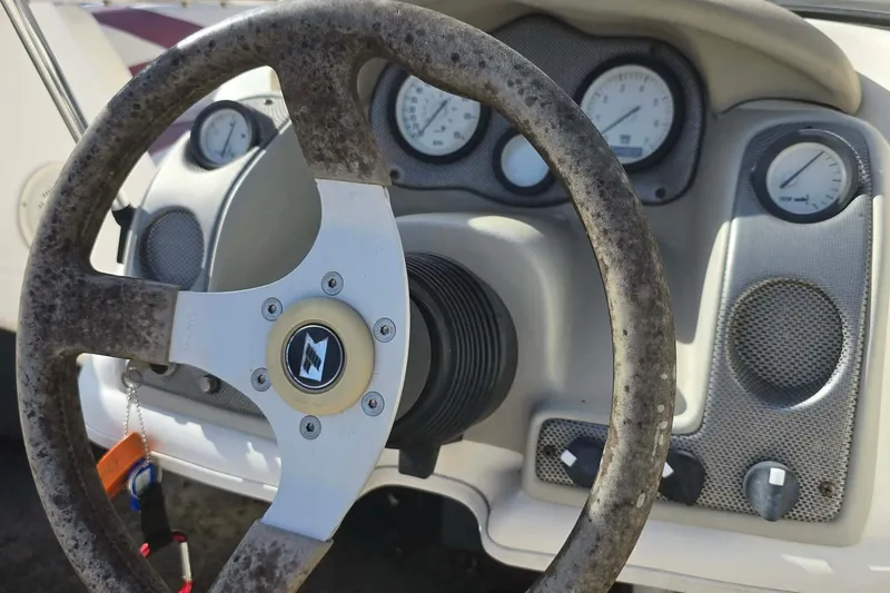 Slide: The Image of 1998 Larson 190 Ski & Fish O/B boat dashboard with steering wheel and gauges. - 15