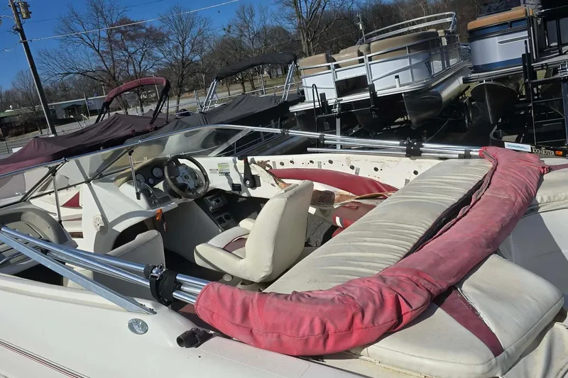 Slide: The Image of 1998 Larson 190 Ski & Fish O/B boat interior with seating and steering wheel. - 4