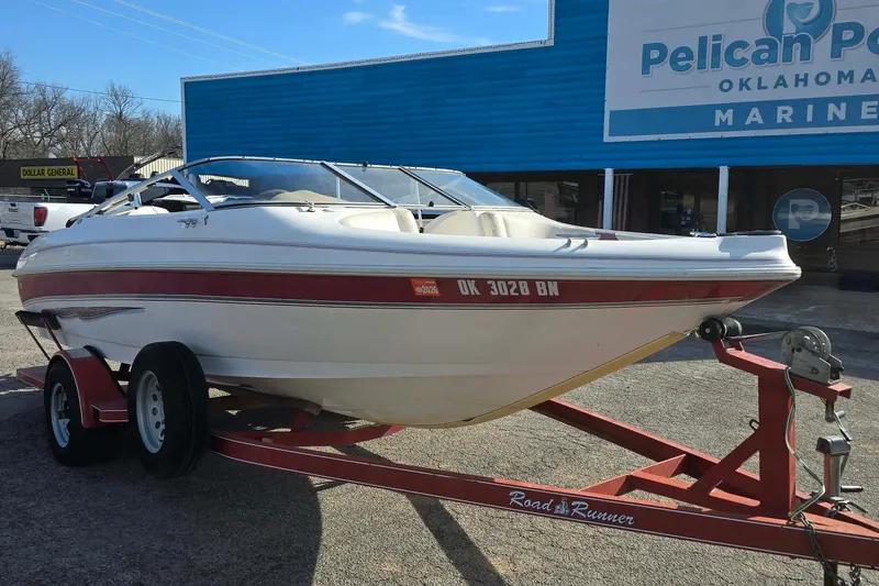 Slide: The Image of 1998 Larson 190 Ski & Fish O/B boat on trailer outside marine store. - 6