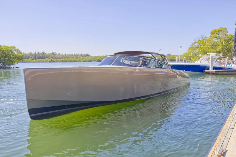 Slide: The Image of 2015 VanDutch 40 luxury yacht docked in a serene marina. - 11