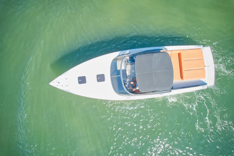 Slide: The Image of Aerial view of 2015 VanDutch 40 yacht cruising on clear green water. - 12