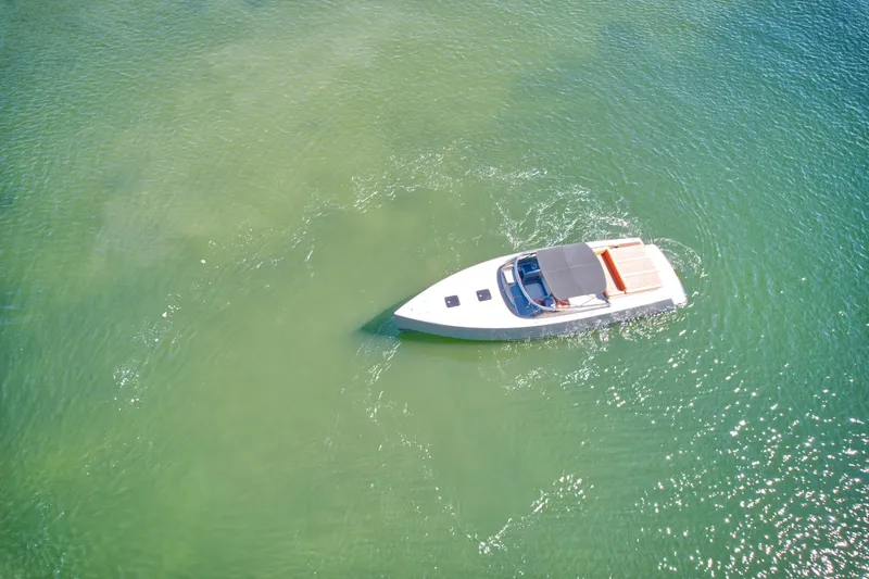 Slide: The Image of Aerial view of 2015 VanDutch 40 yacht cruising on clear green water. - 13