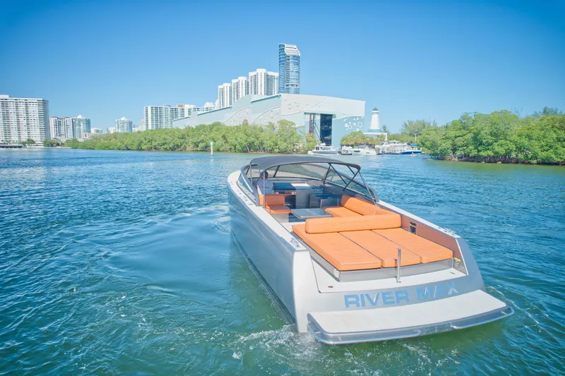 Slide: The Image of 2015 VanDutch 40 luxury yacht cruising near city skyline and waterfront. - 16