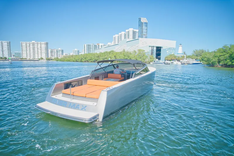 Slide: The Image of 2015 VanDutch 40 luxury yacht cruising in a scenic urban waterway. - 17