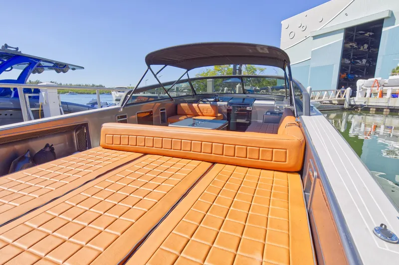 Slide: The Image of 2015 VanDutch 40 luxury yacht with tan leather seating at a marina. - 23