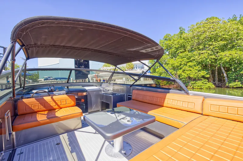 Slide: The Image of 2015 VanDutch 40 yacht with orange seating and shaded deck area. - 29