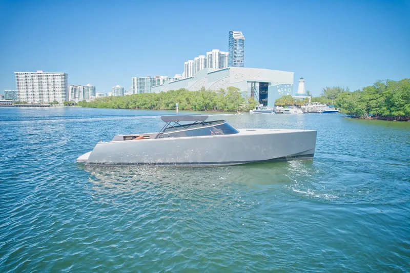 Slide: The Image of 2015 VanDutch 40 yacht cruising in a city waterfront with modern buildings. - 3