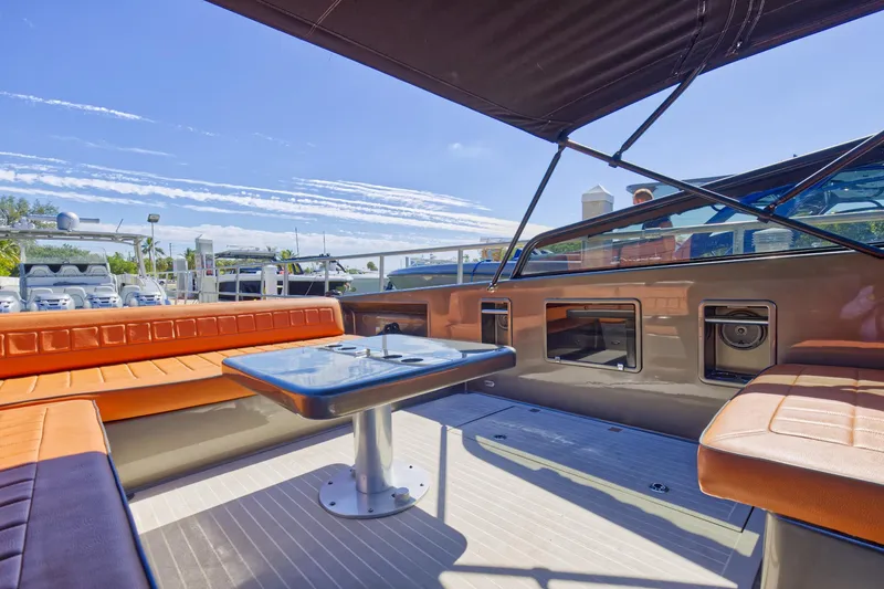 Slide: The Image of Interior of 2015 VanDutch 40 yacht with orange seating and table under canopy. - 30