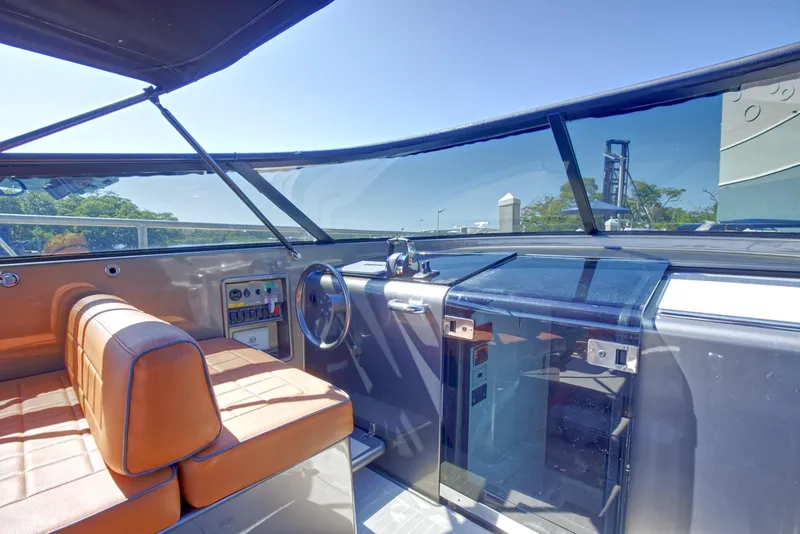Slide: The Image of Interior cockpit of a 2015 VanDutch 40 yacht with orange seating and modern controls. - 34