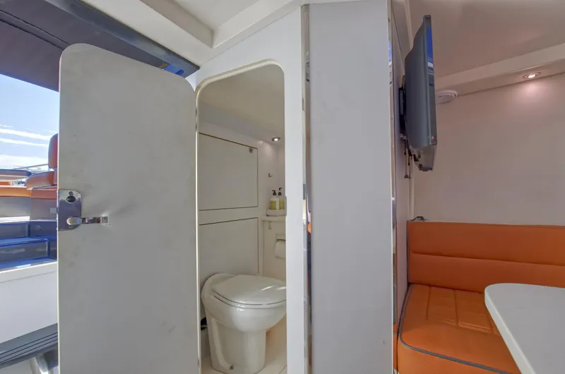 Slide: The Image of VanDutch 40 2015 yacht interior with bathroom and orange seating area. - 37
