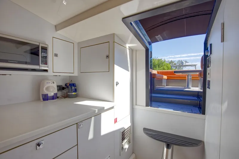 Slide: The Image of Interior of 2015 VanDutch 40 yacht with kitchenette and outdoor view. - 39