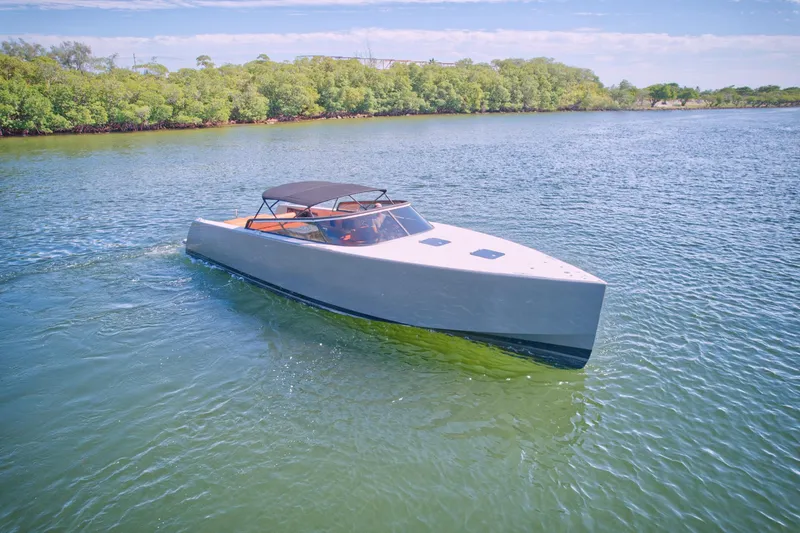 Slide: The Image of 2015 VanDutch 40 luxury yacht cruising on a serene waterway. - 5