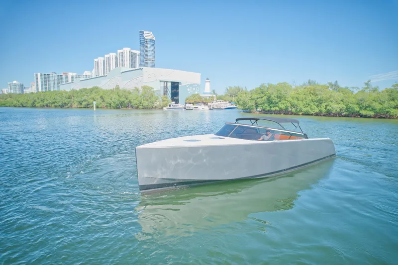 Slide: The Image of 2015 VanDutch 40 yacht cruising near a city waterfront with modern buildings. - 8