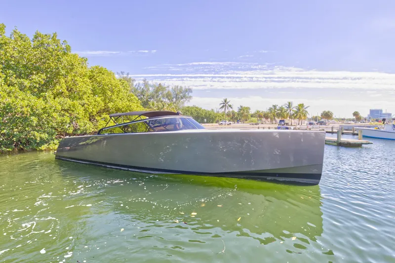 Slide: The Image of 2015 VanDutch 40 yacht docked in a serene, tropical marina. - 9