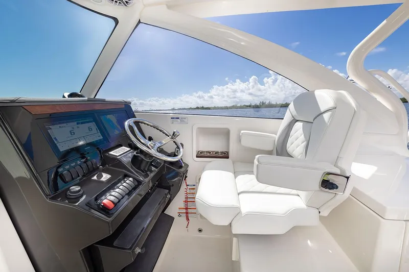 Slide: The Image of Manufacturer Provided Image: 2025 Pursuit DC 306 Dual Console interior with modern helm and luxurious seating. - 10