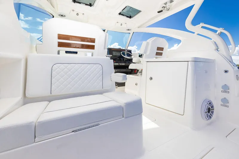 Slide: The Image of Manufacturer Provided Image: Luxurious interior of 2025 Pursuit DC 306 Dual Console boat with white seating. - 12