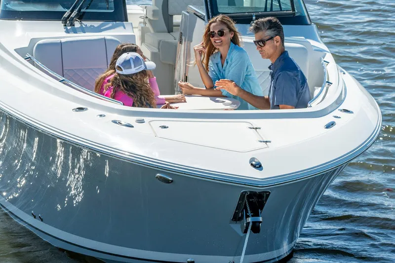 Slide: The Image of Manufacturer Provided Image: 2025 Pursuit DC 306 Dual Console boat with people enjoying a sunny day on the water. - 4