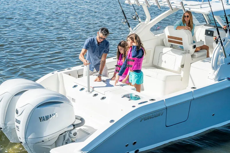 Slide: The Image of Manufacturer Provided Image: Family enjoying a 2025 Pursuit DC 306 Dual Console boat on the water. - 5