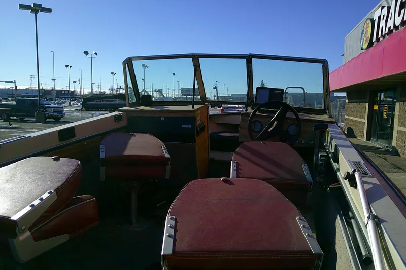Slide: The Image of Interior of a 1983 L 4.9 TYEE boat with red seats and steering wheel. - 4