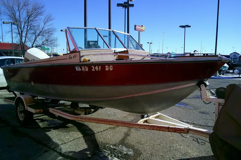 Slide: The Image of 1983 L 4.9 TYEE boat on trailer in parking lot, sunny day. - 6