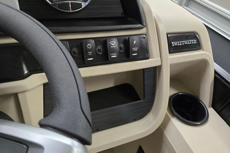 Slide: The Image of 2026 Godfrey Sweetwater 2286 DT dashboard with steering wheel and control switches. - 12