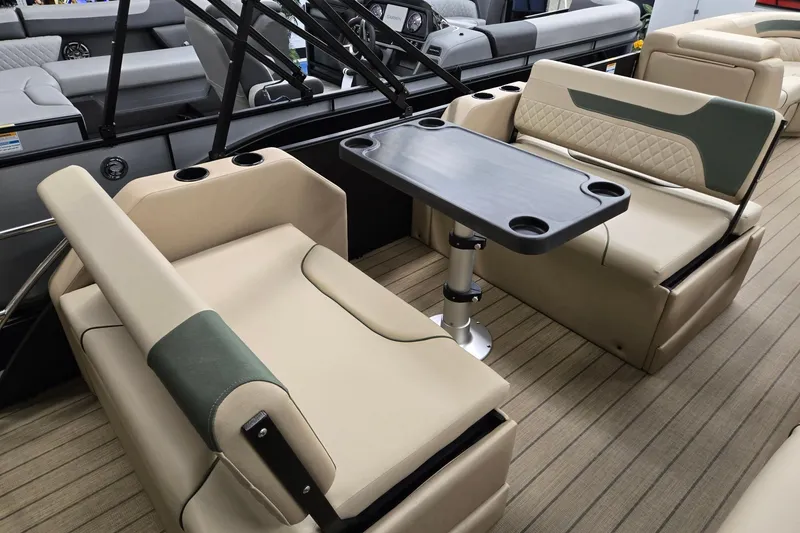 Slide: The Image of 2026 Godfrey Sweetwater 2286 DT boat interior with beige seating and table. - 19