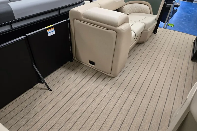 Slide: The Image of 2026 Godfrey Sweetwater 2286 DT interior with beige seating and striped flooring. - 22