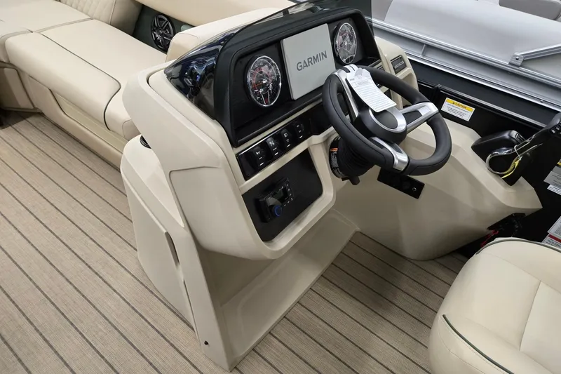 Slide: The Image of 2026 Godfrey Sweetwater 2286 DT boat interior with Garmin dashboard and beige seating. - 23