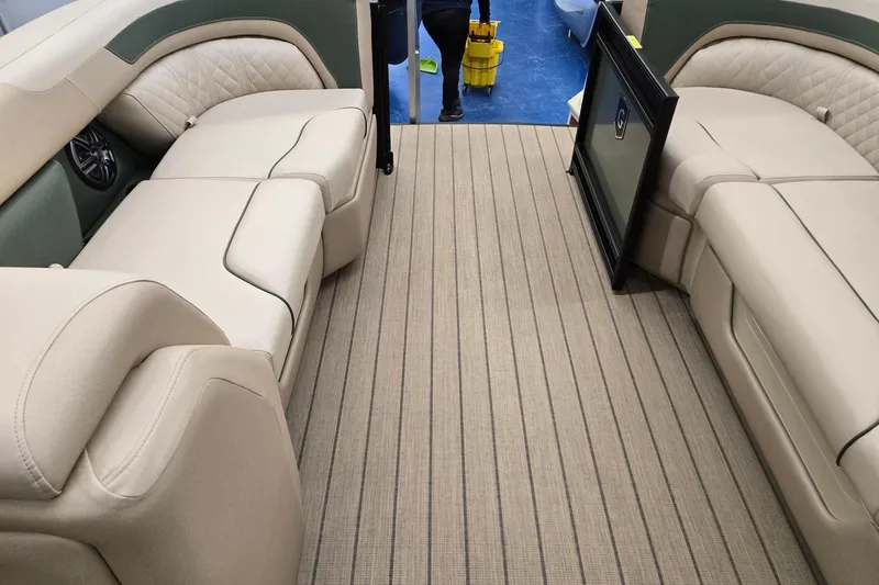 Slide: The Image of Interior of 2026 Godfrey Sweetwater 2286 DT pontoon boat with beige seating and striped flooring. - 24