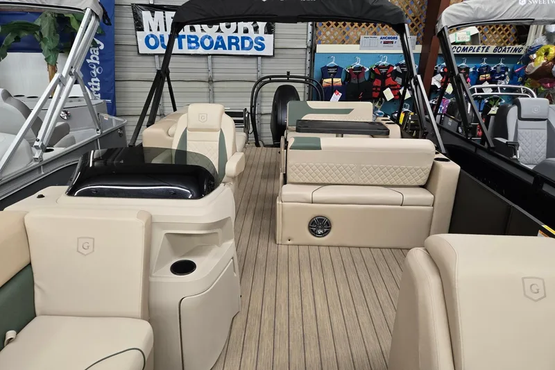 Slide: The Image of 2026 Godfrey Sweetwater 2286 DT pontoon boat interior with beige seating and wood flooring. - 4