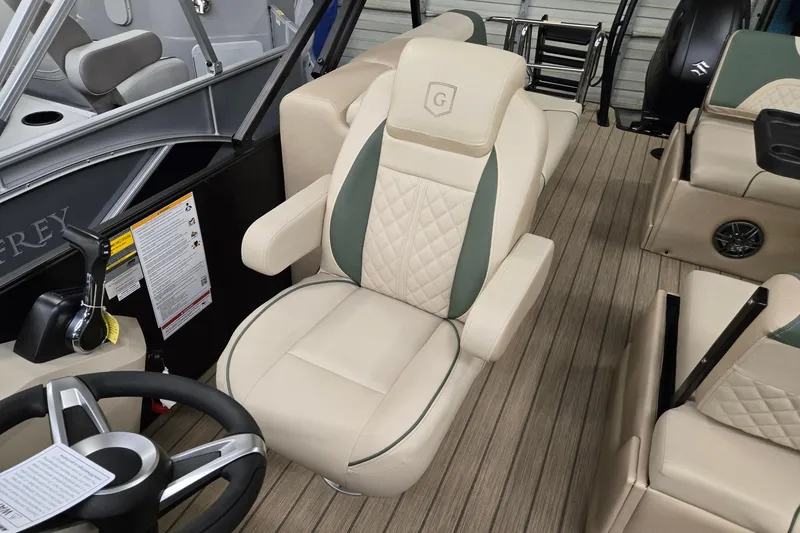 Slide: The Image of 2026 Godfrey Sweetwater 2286 DT boat interior with luxurious seating and steering wheel. - 9