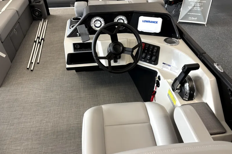 Slide: The Image of Interior of 2025 Crest 22 SLC Classic LX boat with steering wheel and control panel. - 2