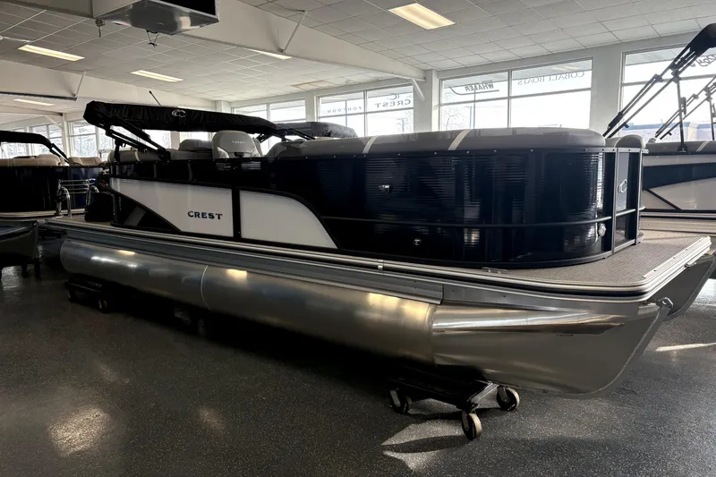 Slide: The Image of 2025 Crest 22 SLC Classic LX pontoon boat displayed in showroom. - 3
