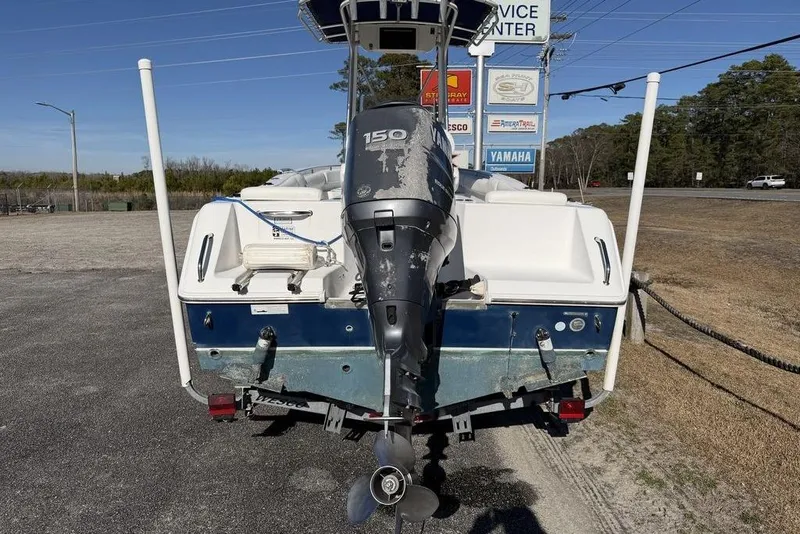 Slide: The Image of 2011 Sea Hunt Triton 225 boat with Yamaha 150 outboard motor, parked outdoors. - 12