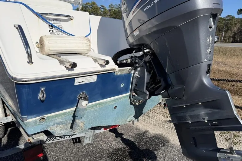 Slide: The Image of 2011 Sea Hunt Triton 225 boat with outboard motor on trailer. - 13