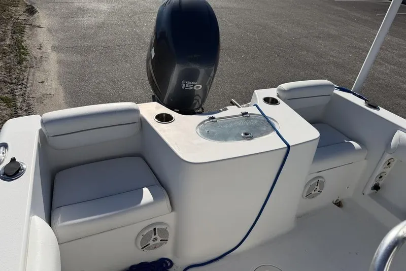 Slide: The Image of 2011 Sea Hunt Triton 225 boat interior with Yamaha 150 engine, featuring seating and storage. - 8