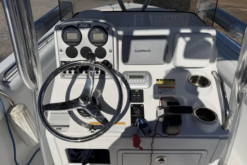 Slide: The Image of 2011 Sea Hunt Triton 225 boat dashboard with Garmin navigation system and steering wheel. - 9
