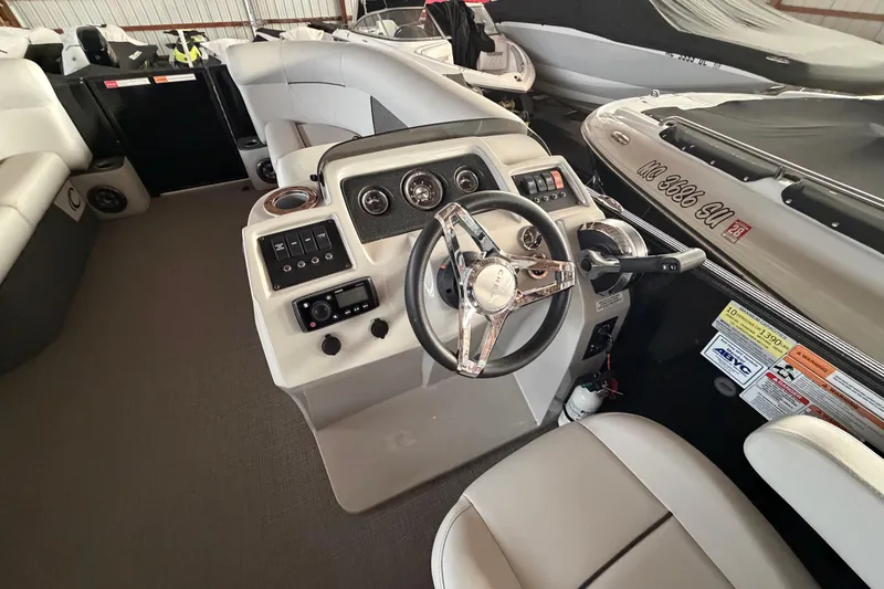 Slide: The Image of 2021 Crest Classic LX 200 L boat interior with steering wheel and control panel. - 11