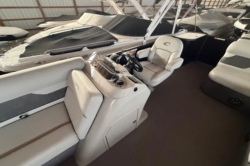Slide: The Image of 2021 Crest Classic LX 200 L pontoon boat interior with helm and seating. - 14