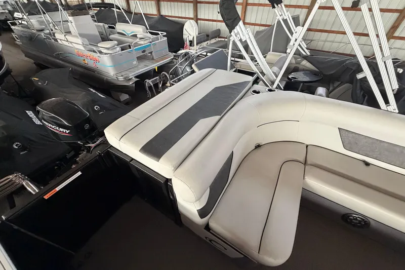 Slide: The Image of 2021 Crest Classic LX 200 L pontoon boat with spacious seating in storage facility. - 18