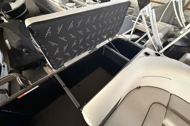 Slide: The Image of 2021 Crest Classic LX 200 L boat interior with open storage compartment. - 19