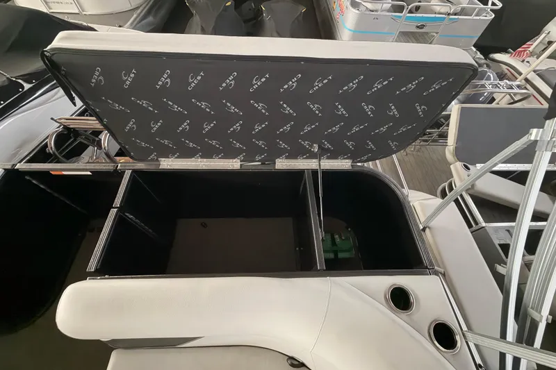 Slide: The Image of 2021 Crest Classic LX 200 L boat with open storage compartment and seating. - 20