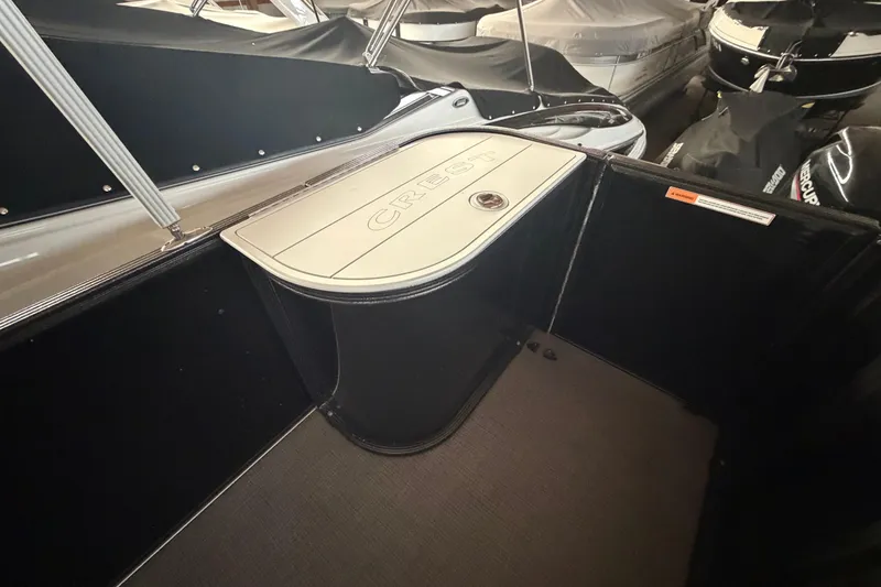 Slide: The Image of 2021 Crest Classic LX 200 L boat interior with storage compartment. - 21