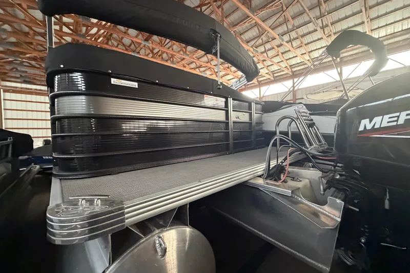 Slide: The Image of 2021 Crest Classic LX 200 L pontoon boat in a storage facility. - 7