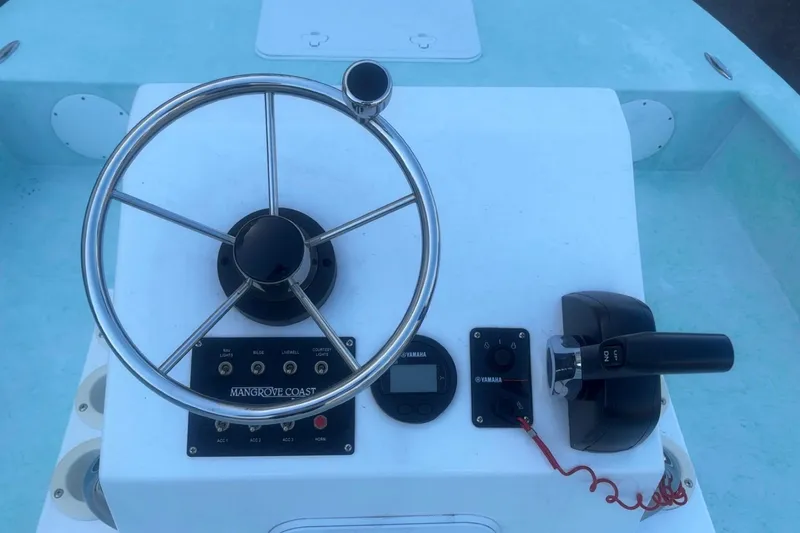 Slide: The Image of Steering console of 2025 Mangrove Coast Boats 1700 Harbor Hawk with controls and gauges. - 10