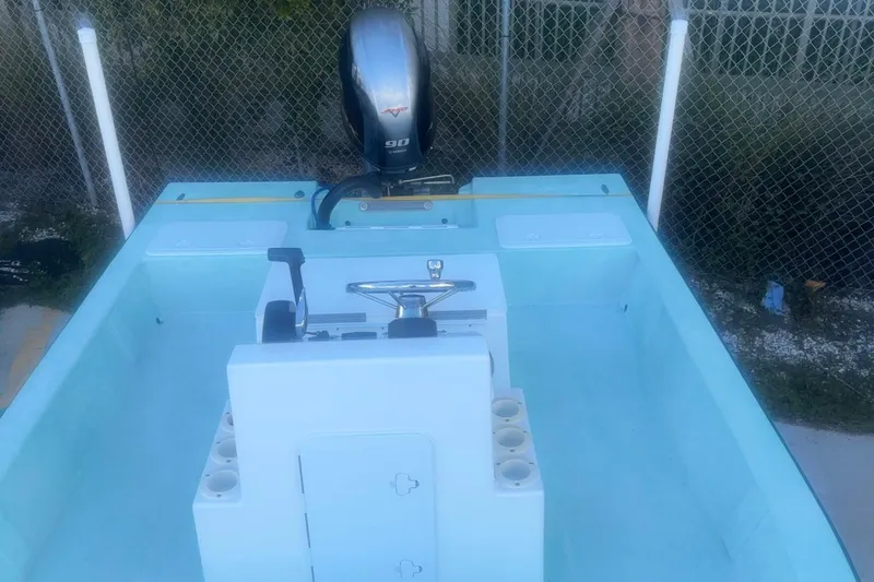 Slide: The Image of 2025 Mangrove Coast Boats 1700 Harbor Hawk with outboard motor, light blue interior. - 4