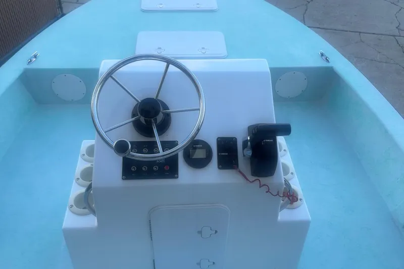 Slide: The Image of 2025 Mangrove Coast Boats 1700 Harbor Hawk steering console with controls and steering wheel. - 5
