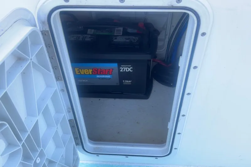 Slide: The Image of Battery compartment of 2025 Mangrove Coast Boats 1700 Harbor Hawk, featuring EverStart Marine battery. - 9